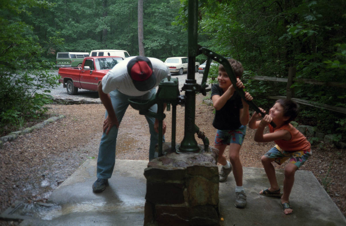 Jordan and Kevin pumping water for Mike, 1989