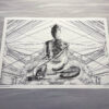 photo of a print by luke kurtis showing a seated buddha surrounded by an abstract design made from patterns of overhead electric wires photographed on the street in Siem Reap, Cambodia