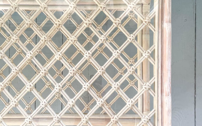 looking down at a glass table with multiple layers, artists barefoot feet at the edge of the photo