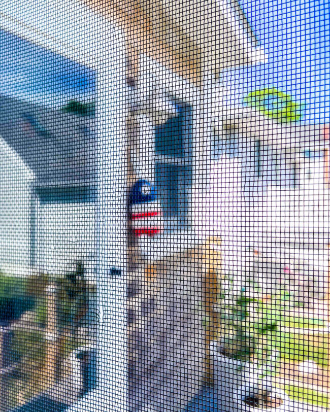 looking outside a house through a window screen