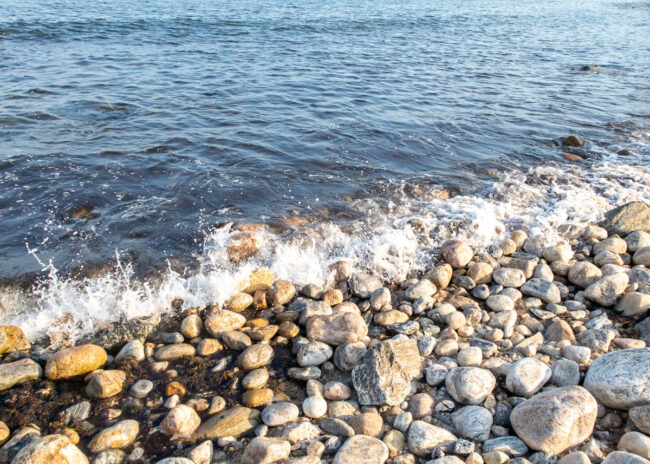 waves breaking on a stone beach