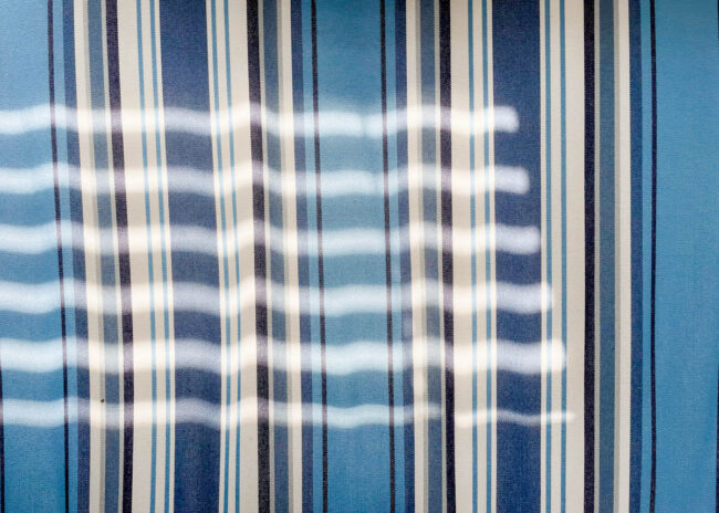 abstract shadows on a blue striped surface